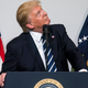 Trump looking up at a 15-foot inflatable rat, hopefully. (Photo: Pool/Getty Images)